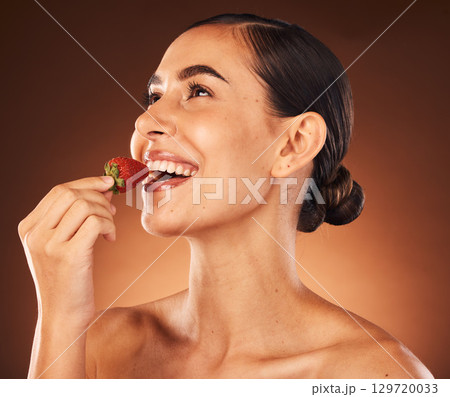 Beauty, skin and skincare, woman with strawberry in healthy, vegan and clean cosmetics product, facial and natural treatment against studio background. Fruit, wellness and organic make up advertising 129720033