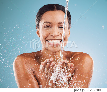 Cleaning, water and black woman with skincare health, beauty wellness and happy shower against blue background in studio. Water splash, cosmetic smile and face portrait of a model with body self care Cleaning, water and black woman with skincare health, beauty wellness and happy shower against blue background in studio. Water splash, cosmetic smile and face portrait of a model with body self care 129720098