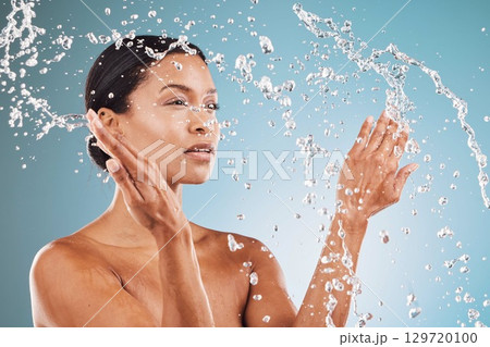 Beauty, skincare and black woman with splash of water for cleaning, hygiene and body care routine. Self care, wellness and healthy skin of model thinking with water splash in blue studio. Beauty, skincare and black woman with splash of water for cleaning, hygiene and body care routine. Self care, wellness and healthy skin of model thinking with water splash in blue studio. 129720100