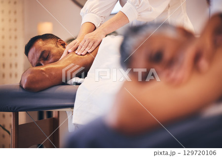 Massage, relax and stress relief with a couple in a spa, lying on a table or bed for luxury and wellness. Health, zen and peace with a senior man and woman in a salon for physical therapy on vacation 129720106