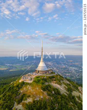 Jested Mountain Hotel stands tall against a vibrant sunset in Liberec. The modern design contrasts with the natural landscape, making it a perfect spot for evening visits and views. Jested Mountain Hotel stands tall against a vibrant sunset in Liberec. The modern design contrasts with the natural landscape, making it a perfect spot for evening visits and views. 129720115