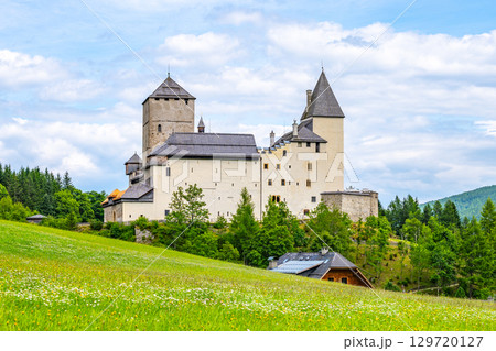 Mauterndorf Castle stands majestically amidst the green meadows of the Austrian Alps. Surrounded by trees and mountains, this historic site showcases medieval architecture and serene landscapes. Mauterndorf Castle stands majestically amidst the green meadows of the Austrian Alps. Surrounded by trees and mountains, this historic site showcases medieval architecture and serene landscapes. 129720127