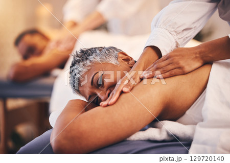 Couple at spa for massage, therapist hands and relax, wellness and holistic health with peace, zen and skincare. Beauty salon, luxury service with treatment and body care for calm and stress relief. 129720140
