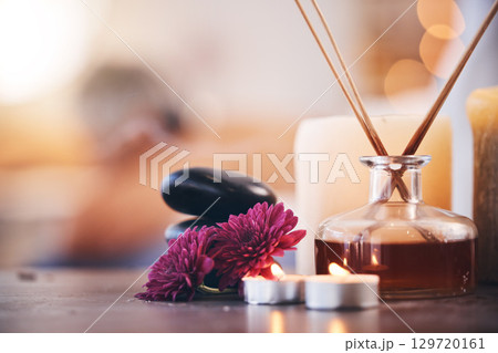Hot stones, candles and aroma oils in relax spa, hotel salon or self care retreat for healthcare wellness, massage or luxury peace. Zoom, texture and incense scent on table in beauty or empty clinic 129720161