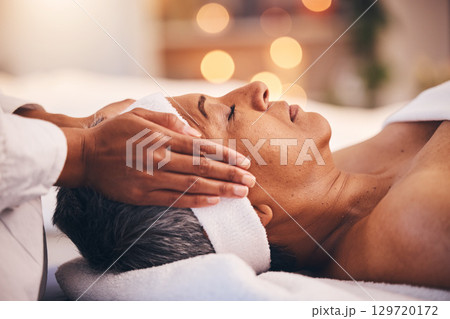 Wellness, health and massage, senior woman at a spa getting luxury beauty therapy and facial. Mature black woman, zen and masseuse massaging oil on head to help relax body and mind for stress relief. Wellness, health and massage, senior woman at a spa getting luxury beauty therapy and facial. Mature black woman, zen and masseuse massaging oil on head to help relax body and mind for stress relief. 129720172