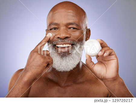 Cream, senior man and skincare for natural beauty, organic facial or hygiene on grey studio background. Portrait, cosmetics or healthy mature black male with lotion for wellness, clear face or health 129720217