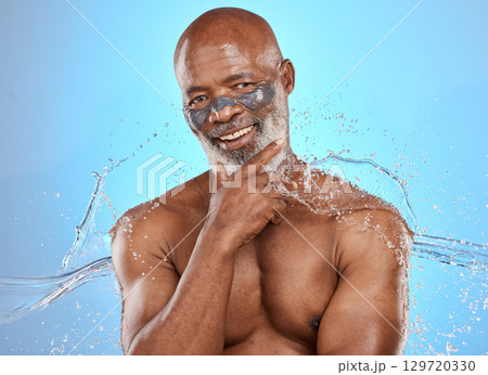 Skincare, water and facial for black man on blue background for wellness, hydration and spa. Dermatology, beauty and portrait of elderly male with skincare products, facial mask and water splash 129720330