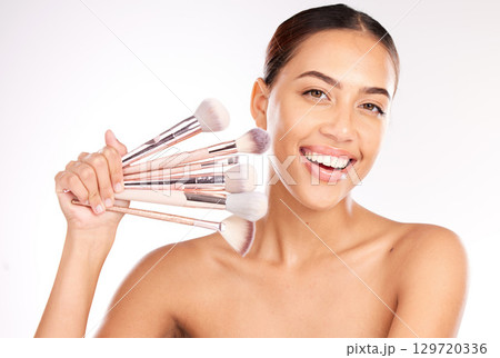 Beauty, makeup and brush with portrait of woman for product, facial and salon. Smile, luxury and cosmetics with foundation tool and girl model for cosmetology, application or care in white background Beauty, makeup and brush with portrait of woman for product, facial and salon. Smile, luxury and cosmetics with foundation tool and girl model for cosmetology, application or care in white background 129720336