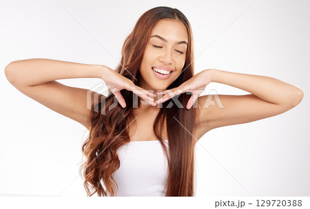 Beauty, hair and keratin with a model black woman in studio on a gray background for natural haircare treatment. Happy, smile and hairstyle with an attractive young female posing to promote hair care Beauty, hair and keratin with a model black woman in studio on a gray background for natural haircare treatment. Happy, smile and hairstyle with an attractive young female posing to promote hair care 129720388