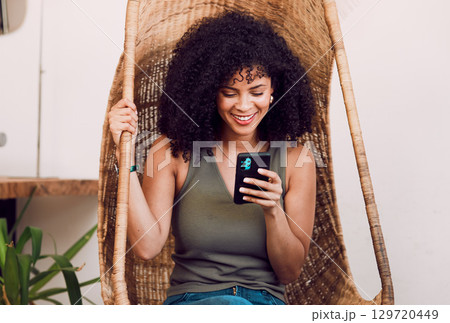 Black woman, phone and smile for communication, social media and streaming online with wifi in a rustic wood swing chair. Female with a smile, smartphone and happiness during chat on network 129720449