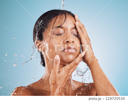 Skincare, beauty and water splash for cleaning, facial and wellness of skin, body and face on blue studio background. Aesthetic model for self care, dermatology and cosmetics for luxury skin 129720530
