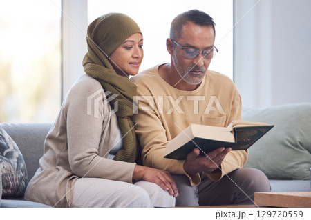 Muslim couple, reading Quran and spiritual with islam, hijab and book for faith, trust and learning scripture in home. Islamic man, woman and read religious book, support and learn on eid Mubarak Muslim couple, reading Quran and spiritual with islam, hijab and book for faith, trust and learning scripture in home. Islamic man, woman and read religious book, support and learn on eid Mubarak 129720559