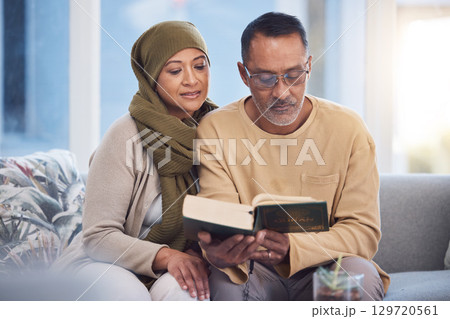 Reading, book and eid mubarak with a muslim couple in the living room of their home together with the quran. God, Islam and ramadan with a man and woman bonding over religion in their house Reading, book and eid mubarak with a muslim couple in the living room of their home together with the quran. God, Islam and ramadan with a man and woman bonding over religion in their house 129720561
