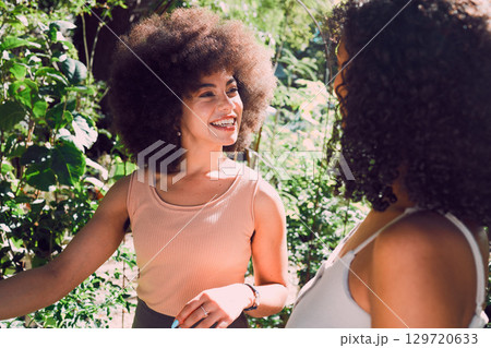 Park talking, black woman and friends gossip, communication and chat about nature beauty, agriculture or plant growth. Peace, freedom and African people in conversation, speaking or gen z discussion 129720633