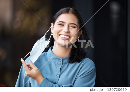 Covid, freedom and finished with a woman mask removal with a smile outdoor in the fresh air. Health, safety and portrait with a female excited to stop or complete corona virus epidemic regulations 129720659