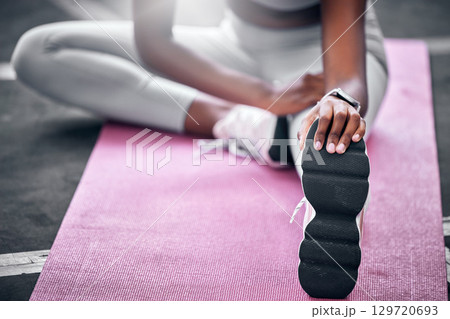 Woman, relax and stretching legs for workout exercise on gym or yoga studio floor. Personal trainer, fitness and wellness flexibility or healthy body, release tension or muscle cardio sports warm up 129720693