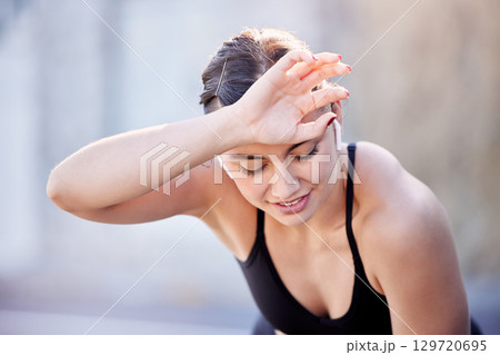 Fitness music, sweat and woman tired after outdoor running, cardio workout or marathon race training. Radio podcast, wellness and exhausted athlete runner with fatigue after sports performance action 129720695