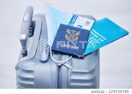 Covid, passport and suitcase for travel compliance, policy and documents in global, airport or visa information background. Corona, virus or covid 19 brochure with identity document, visa and luggage Covid, passport and suitcase for travel compliance, policy and documents in global, airport or visa information background. Corona, virus or covid 19 brochure with identity document, visa and luggage 129720740