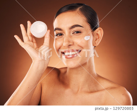 Cream, skincare and beauty woman in studio portrait for cosmetics product promotion, marketing and advertising. Model headshot or face for skin care serum glow or shine results in dermatology mockup 129720803