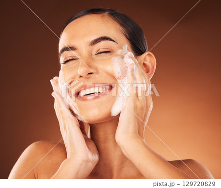 Skincare, hands and foam on face for cleaning with smile, happiness and spa wellness. Facial wash, luxury cosmetics therapy and self care with soap for beauty, dermatology grooming and cosmetology 129720829