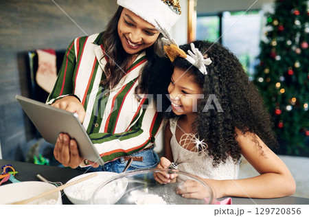 Christmas, tablet and cooking family with child and mother reading online recipe, website information and food blog for holiday. Black family mom teaching kid with technology, kitchen and baking app Christmas, tablet and cooking family with child and mother reading online recipe, website information and food blog for holiday. Black family mom teaching kid with technology, kitchen and baking app 129720856
