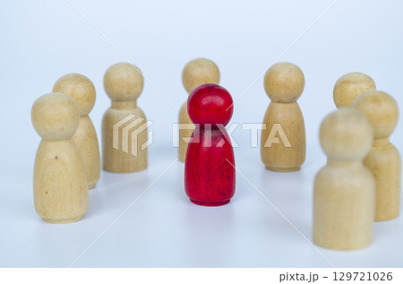 A red figure positioned among wooden groups equally, representing inclusion and diversity of it can also be discrimination concept 129721026