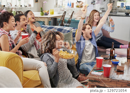 Celebration, diversity and excited people watching tv, global sports event or world cup competition winner. Pride, wow goals and team support energy of social fans streaming game with beer and snacks Celebration, diversity and excited people watching tv, global sports event or world cup competition winner. Pride, wow goals and team support energy of social fans streaming game with beer and snacks 129721054