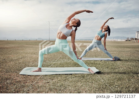 Pilates, exercise and wellness with woman friends in the park together for mental health or fitness. Exercise, zen and training with a female and yoga friend outside on a field for a summer workout Pilates, exercise and wellness with woman friends in the park together for mental health or fitness. Exercise, zen and training with a female and yoga friend outside on a field for a summer workout 129721137