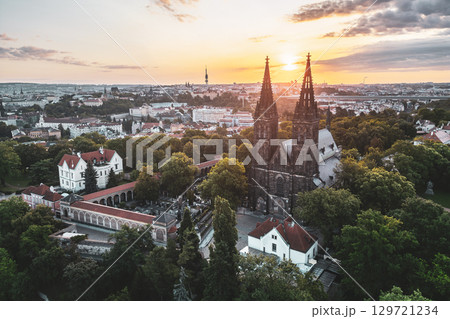 Morning light illuminates Vysehrad Basilica of St. Peter and St. Paul, showcasing its stunning architecture against a backdrop of Prague's skyline and lush greenery. Morning light illuminates Vysehrad Basilica of St. Peter and St. Paul, showcasing its stunning architecture against a backdrop of Prague's skyline and lush greenery. 129721234