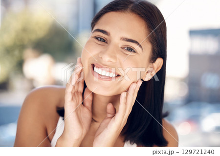 Face, beauty and skincare with a woman in the bathroom of her home for facial cleaning or hygiene. Portrait, skin and cosmetics with an attractive young female applying luxury product to her skin 129721240