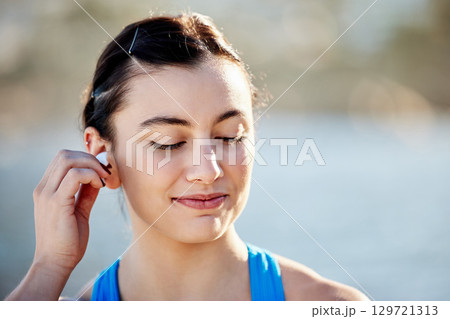 Fitness, podcast and sports woman in headphones ready to start training, running exercise or cardio workout in nature. Runner, relaxing and happy girl in earphones listening or streaming radio music 129721313