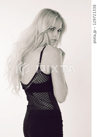Black and white, fashion and portrait of woman in studio isolated on a background. Beauty, aesthetic and confident female model from Canada posing in stylish, edgy or designer brand apparel or outfit 129721338