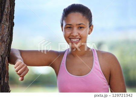 Fitness, portrait and black woman in nature to relax by a tree after running exercise, training or workout in summer. Park, sports and healthy girl runner resting in natural shade in South Africa 129721342