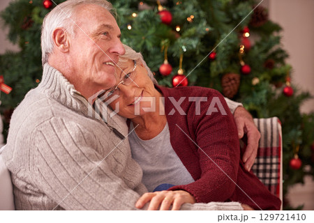 Christmas, love and senior couple hug on sofa in home, affection and bonding. Romance, xmas holiday and happy elderly, retired woman and man embrace on couch enjoying quality time together in house 129721410