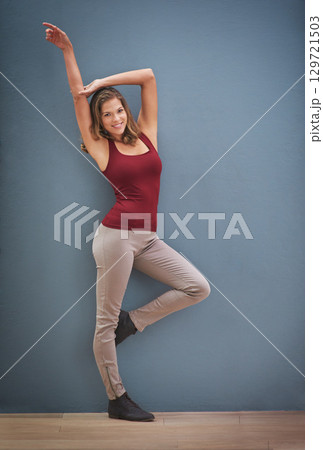 Portrait, fashion and mockup with a model woman in studio on a gray wall background for style or clothes. Happy, smile and trendy with an attractive young female posing to promote a clothing brand Portrait, fashion and mockup with a model woman in studio on a gray wall background for style or clothes. Happy, smile and trendy with an attractive young female posing to promote a clothing brand 129721503