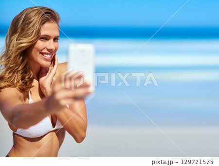 Influencer, phone and woman taking a selfie at a beach for a social media audience or travel blog online in Sao Paulo, Brazil. Model, content creator or happy girl taking pictures in summer in bikini Influencer, phone and woman taking a selfie at a beach for a social media audience or travel blog online in Sao Paulo, Brazil. Model, content creator or happy girl taking pictures in summer in bikini 129721575