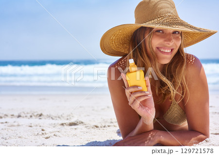 Young woman, beach and sunscreen for protection, smile and happiness on sand. Female, girl with suntan lotion for skincare, prevent sunburn and happiness on vacation with sun blocker and seaside. Young woman, beach and sunscreen for protection, smile and happiness on sand. Female, girl with suntan lotion for skincare, prevent sunburn and happiness on vacation with sun blocker and seaside. 129721578