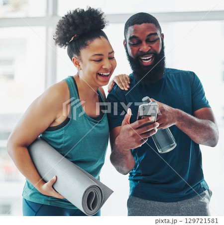 Phone, meme or yoga friends on social media laughing at funny online content after a fitness class. Pilates, black woman and happy African personal trainer relaxing or enjoying crazy comedy together 129721581