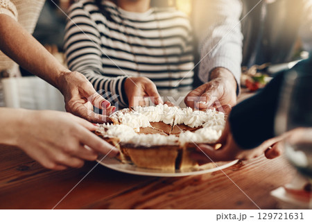 People, hands and pumpkin pie at a party for a thanksgiving celebration, event or gathering at home. Traditional dessert, cake or pie at a holiday dinner, lunch or meal in the dining room at a house. People, hands and pumpkin pie at a party for a thanksgiving celebration, event or gathering at home. Traditional dessert, cake or pie at a holiday dinner, lunch or meal in the dining room at a house. 129721631