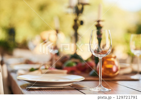 Restaurant, wine glass and table for dinner, party or thanksgiving celebration with luxury, winery and hospitality industry, Patio, plate and outdoor eating experience for lunch or drink background Restaurant, wine glass and table for dinner, party or thanksgiving celebration with luxury, winery and hospitality industry, Patio, plate and outdoor eating experience for lunch or drink background 129721791