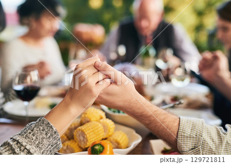 Party, food and family holding hands for prayer before eating chicken, barbecue or turkey at a social event. Corn, Christmas and Christian friends praying before enjoying meat and vegetables meal Party, food and family holding hands for prayer before eating chicken, barbecue or turkey at a social event. Corn, Christmas and Christian friends praying before enjoying meat and vegetables meal 129721811