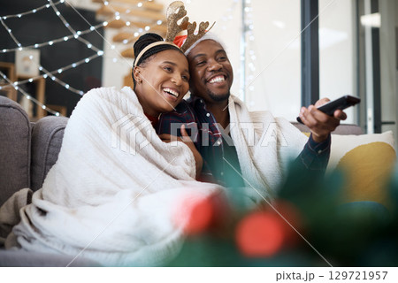 Christmas, comfort and African couple watching tv, news or a movie from the living room sofa. Television, relax and black man and woman on the couch for a film on a subscription service for festive Christmas, comfort and African couple watching tv, news or a movie from the living room sofa. Television, relax and black man and woman on the couch for a film on a subscription service for festive 129721957