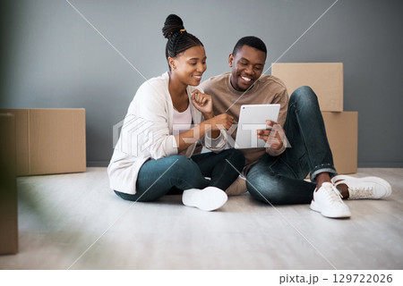 Tablet, box and moving with black couple in new house for planning, real estate and property. Investment, goals and future with man and woman in new home with technology, internet and growth 129722026