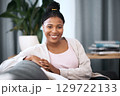 Black woman, smile and portrait on sofa in home with happiness, self love and relax in living room. Happy, African woman and student on lounge couch in house, flat or apartment to rest in free time 129722133