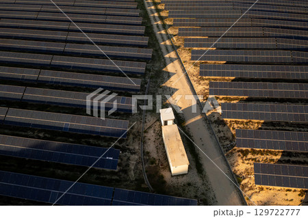 High angle of solar farm with rows of panels 129722777