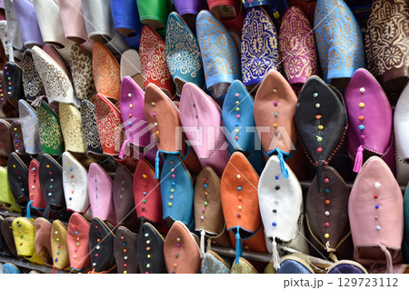 Slippers or sandals of many colors hung from street stalls in Marrakech's souk Slippers or sandals of many colors hung from street stalls in Marrakech's souk 129723112