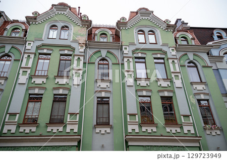 A group of people in front of a building A group of people in front of a building 129723949