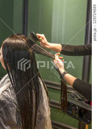 In a beauty salon, a client girl's hair is washed. In a beauty salon, a client girl's hair is washed. 129724084