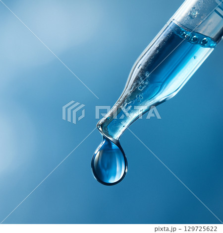 AI generated macro shot of a blue liquid droplet from a glass dropper with a soft blurred blue background symbolizing science medicine and research precision 129725622