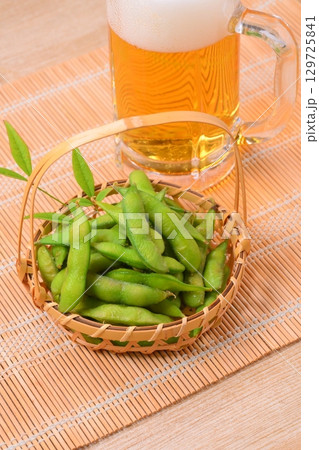 夏の定番おつまみ、枝豆、えだまめ、エダマメ、と生ビール。 夏の定番おつまみ、枝豆、えだまめ、エダマメ、と生ビール。 129725841